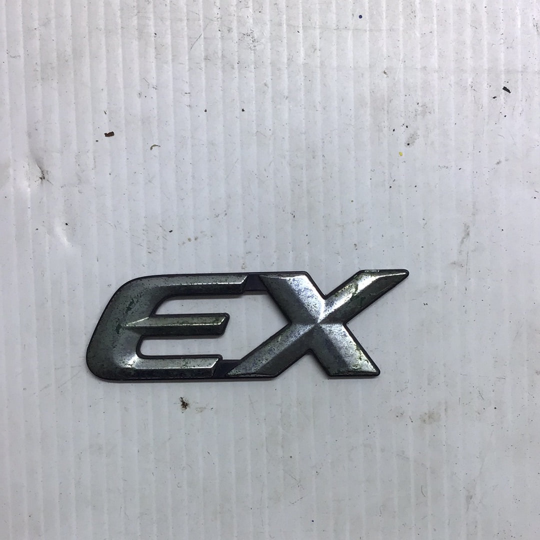 Emblema EX